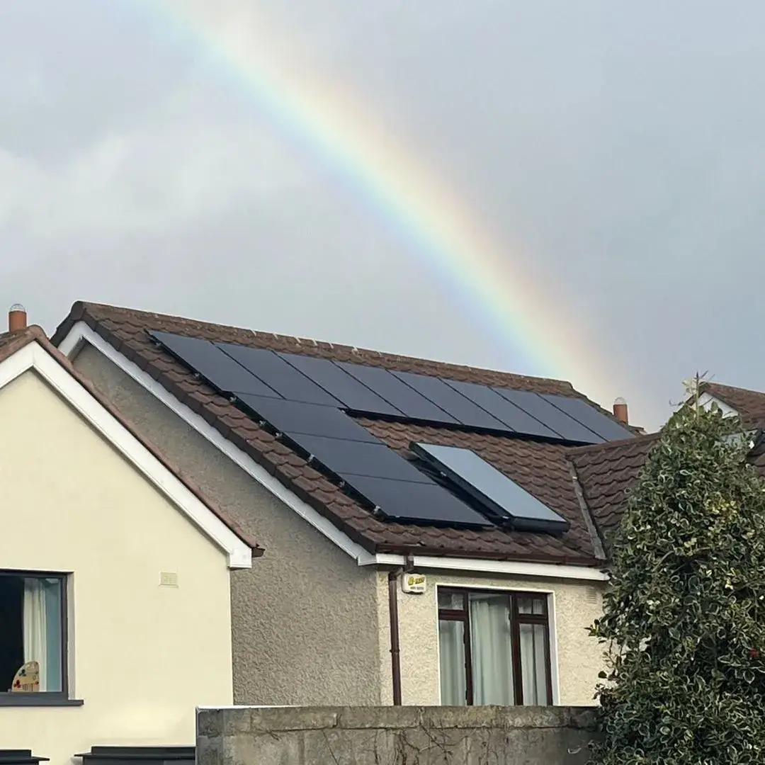 Solar panels on a Dublin home with a rainbow overhead